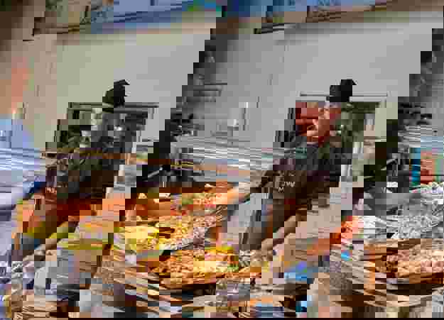 Med Royal Surrey Wellspring Restaurant Staff Member Serving Food From Counter 02 (1)